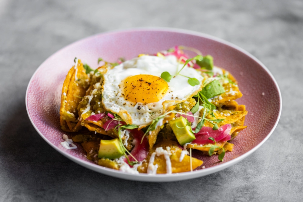 Authentic chilaquiles served with eggs and salsa at Crown Block brunch downtown Dallas.
