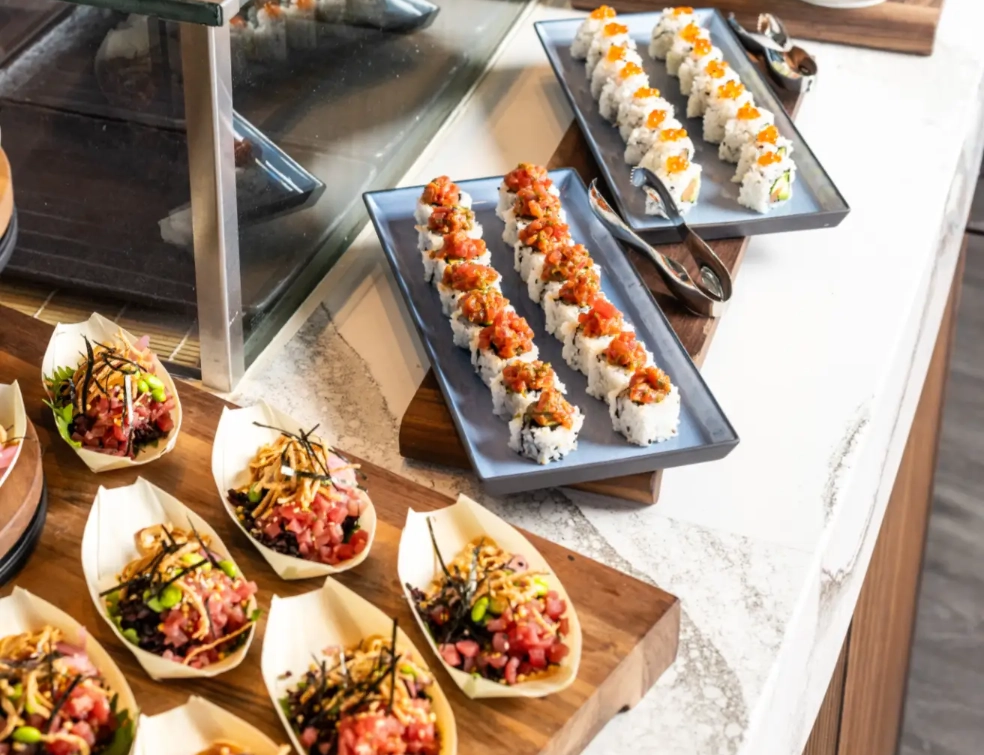 Sushi and seafood station with fresh sushi rolls and oysters at Crown Block Sunday brunch Dallas TX.